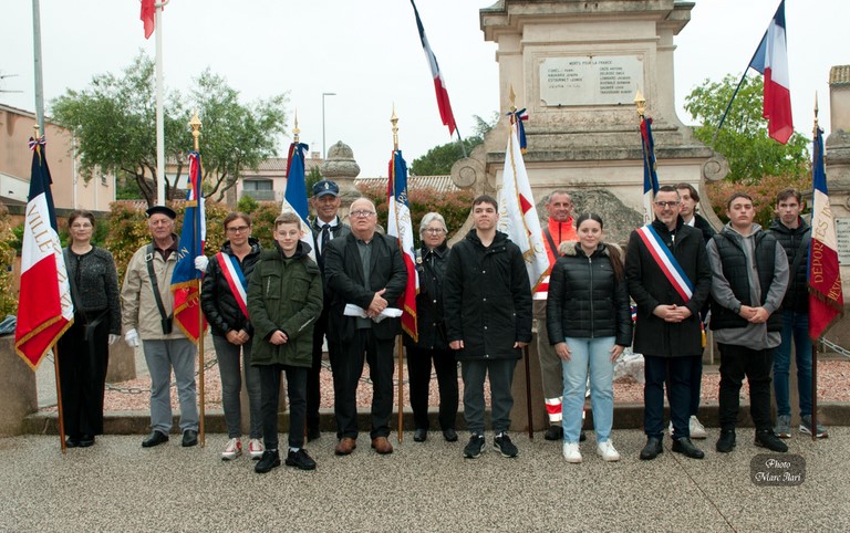 Porte-drapeaux, élus et jeunes devant le monument du Souvenir à l’issue d’une cérémonie marquée par la pluie