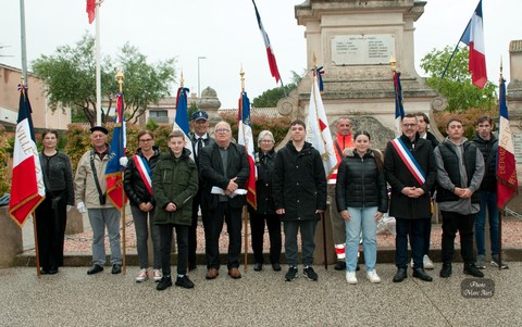 Porte-drapeaux, élus et jeunes devant le monument du Souvenir à l’issue d’une cérémonie marquée par la pluie